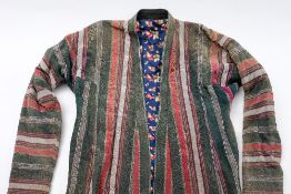 An Uzbek chapan of green , red and silver stripes with printed cotton lining:.