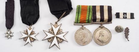 A WWII period Order of St John neck badge:, together with shoulder badge and miniature,