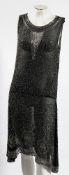 An early 20th century black cotton and beadwork dress:, circa 1920s,