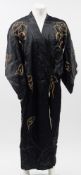 A mid 20th century black silk kimono with embroidered dragon decoration:, .