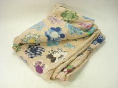 A mid 20th century patchwork quilt: of hexagonal design with floral fabric flowers, 170 x 220cm.