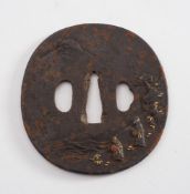 A 19th century Japanese iron tsuba:, with relief decoration of figures on a mountain path,