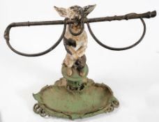A cast iron Coalbrookdale style stick stand in the form of a begging dog with riding whip in its