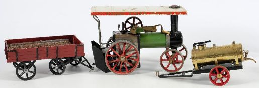 A Mamod live steam traction engine:, in white and green with red spoked wheels,