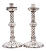 A pair of stylish Continental silver plated candlesticks: with cylindrical nozzles,