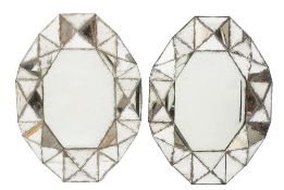 A pair of 'Cubist' style mirrors:, of oval polygonal shape,