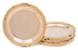 A set of seven 20th century German silver gilt coasters.