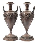 A pair of bronze twin-handled urn lamps: of ovoid tapering form,