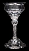 A sweetmeat glass: the panel moulded double ogee bowl with everted rim and basal diamond studs set