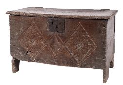 An early 18th Century oak plank coffer:, of small size, with a plain hinged moulded top,
