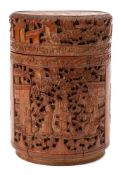 A Chinese carved bamboo cylindrical box and cover: carved overall with figures on terraces, phoenix,