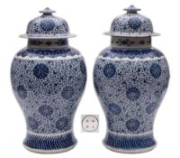 A pair of Chinese blue and white 'peony scroll' baluster jars and covers: painted overall with a