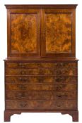 A 19th Century estate cabinet:, in walnut and figured walnut, the upper part with a moulded cornice,