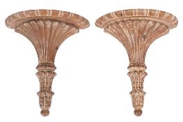 A pair of carved limewood half round wall brackets:,