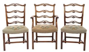 A set of eight 19th Century carved mahogany ladderback dining chairs:, in the George III taste,