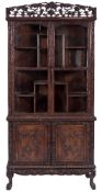 A 19th Century carved hardwood display cabinet:, possibly Goanese,
