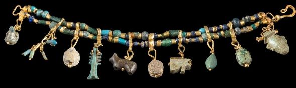 An antique gold, bead and charm bracelet: with two strings of glass,