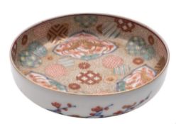 A small Fukugawa dish: the interior decorated with three Phoenix panels reserved on a profuse