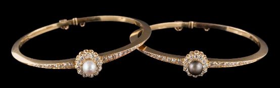 A pair of natural pearl and diamond hinged bangles: each with a central dark grey or white pearl, 6.