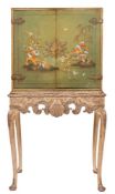 A green lacquer and chinoiserie brass mounted cabinet on carved and silvered wood stand:,