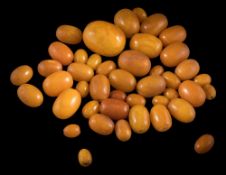 A collection of 43 amber beads: ranging 12mm long x 9mm wide, to 32mm long x 25mm wide,