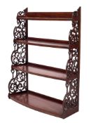 A mahogany four tier graduated bow-fronted hanging open bookcase:,