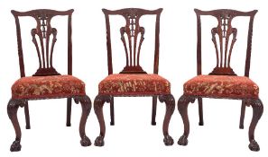 A set of eight carved mahogany dining chairs in the Chippendale taste:,