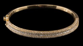 A diamond mounted hinged bangle: with central row of princess-cut diamonds between rows of round