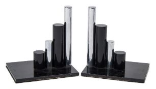 A pair of Modernist bronze and steel bookends: each with four stepped cylindrical rods to a painted