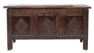 An 18th Century carved oak rectangular coffer:, with a plain hinged moulded top,