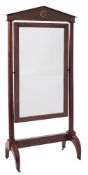 A French Empire mahogany swing frame cheval mirror:, with an architectural pediment,