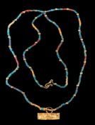 A faience and gold bead single-string necklace: with hook clasp and suspending a rectangular