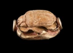 An ancient Egyptian gold mounted scarab seal bead approximately 17mm long,