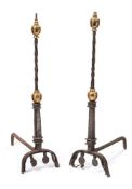 A pair late 17th/early 18th century andirons: the steel spiral twist stems surmounted by brass ball