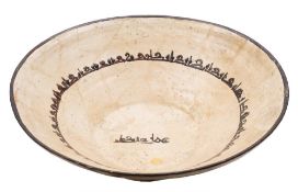 A large Islamic slip-decorated earthenware bowl: of wide conical form,