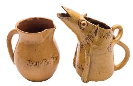 A Ewenny slipware pottery pig jug and a similar baluster jug: both in yellow over brown,