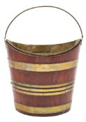 An 18th century mahogany and brass bound navette shaped bucket: of coopered construction,