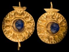 A pair of antique Roman gold and blue glass bead earrings: each with an embossed circular panel