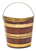 An 18th century mahogany and brass bound navette shaped bucket: of coopered construction,