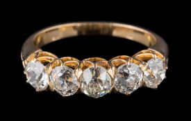 A late 19th century gold and diamond five-stone half-hoop ring: with five slightly graduated round