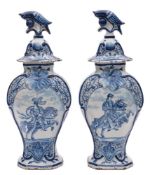 A pair of Dutch blue and white delftware vases and covers: of octagonal baluster form,
