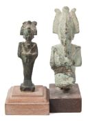 A small bronze figure of Osiris: in standing mummiform pose on a wooden stand;