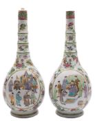 A pair of Canton famille rose bottle vases: with triple ring necks,