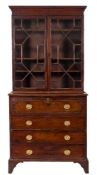 An early 19th Century mahogany secretaire bookcase:, the upper part with a moulded cornice,