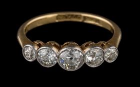 A graduated diamond five-stone ring: with round,