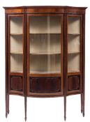 An Edwardian mahogany, ebonised banded and inlaid serpentine fronted display cabinet:,