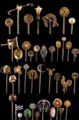 A fox mask hunting stick pin, a blue enamelled horseshoe motif stick pin and a coral mounted,