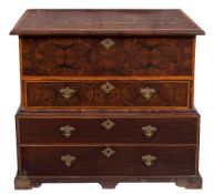 A walnut oyster veneered banded and inlaid chest in the William and Mary taste:, on a later base,