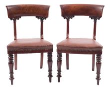 A set of twelve early Victorian mahogany dining chairs: the backs with broad curved bar top rails