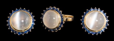 A cat's eye moonstone and sapphire circular cluster ring with matching ear-clips: each ear-clip